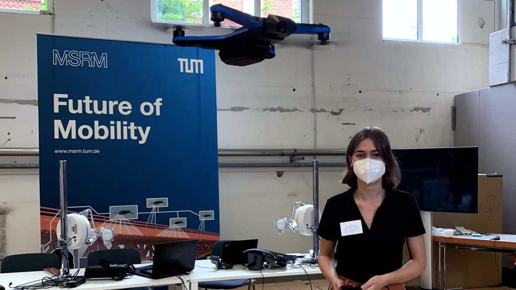 Irene Bruckmeier pilots a drone in front of a MSRM TUM banner that reads, Future of Mobility.